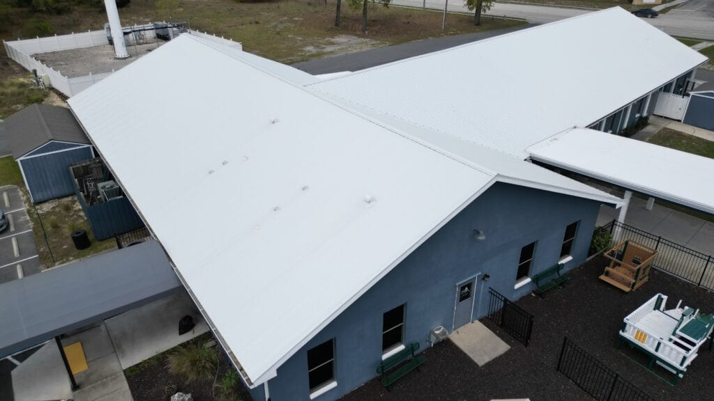 Commercial silicone roof coating installation in Brooksville, FL by Protech Roofing.
